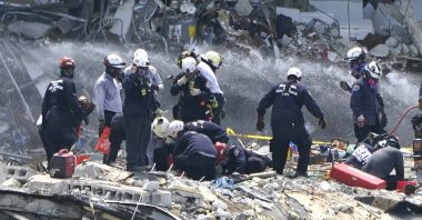 Rescue workers search the rubble of the Champlain Towers South condominium, Surfside, Florida, U.S., June 26, 2021. (AP Photo)