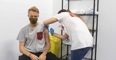 A man receives a dose of a COVID-19 vaccine at a mass coronavirus vaccination center in Arsenal's Emirates Stadium, London, U.K., June 25, 2021. (AP Photo)