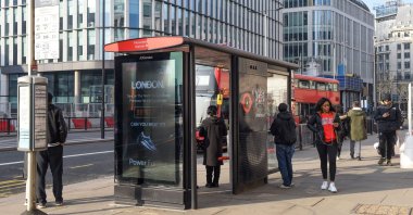 Commuters waiting for the bus at a bus stop in London, U.K., March 2, 2021. (Reuters Photo)