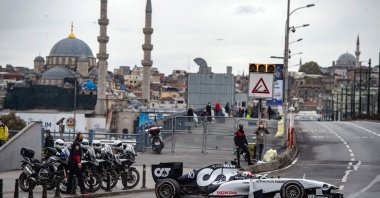 Scuderia AlphaTauri Honda French Formula One driver Pierre Gasly drives his car across the Galata Bridge while shooting a Formula One promotional movie in Istanbul, Turkey, Nov. 10, 2020. (AFP Photo)