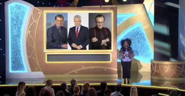 Host Sheryl Underwood introduces a tribute to the late talk show hosts, pictured on screen from Regis Philbin (L), Alex Trebek (C) and Larry King during the 48th Daytime Emmy Awards, June 25, 2021. (Daytime Emmys via AP)