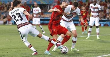 Belgium's Yannick Carrasco in action with Portugal's Ruben Dias and Joao Felix Pool, Seville, Spain, June 27, 2021. (Reuters Photo)