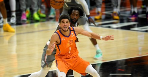 Phoenix Suns guard Devin Booker (front) is shadowed by Los Angeles Clippers guard Patrick Beverley in Game 4 of 2021 NBA Playoffs Western Conference Finals at Staples Center, Los Angeles, California, U.S., June 27, 2021.