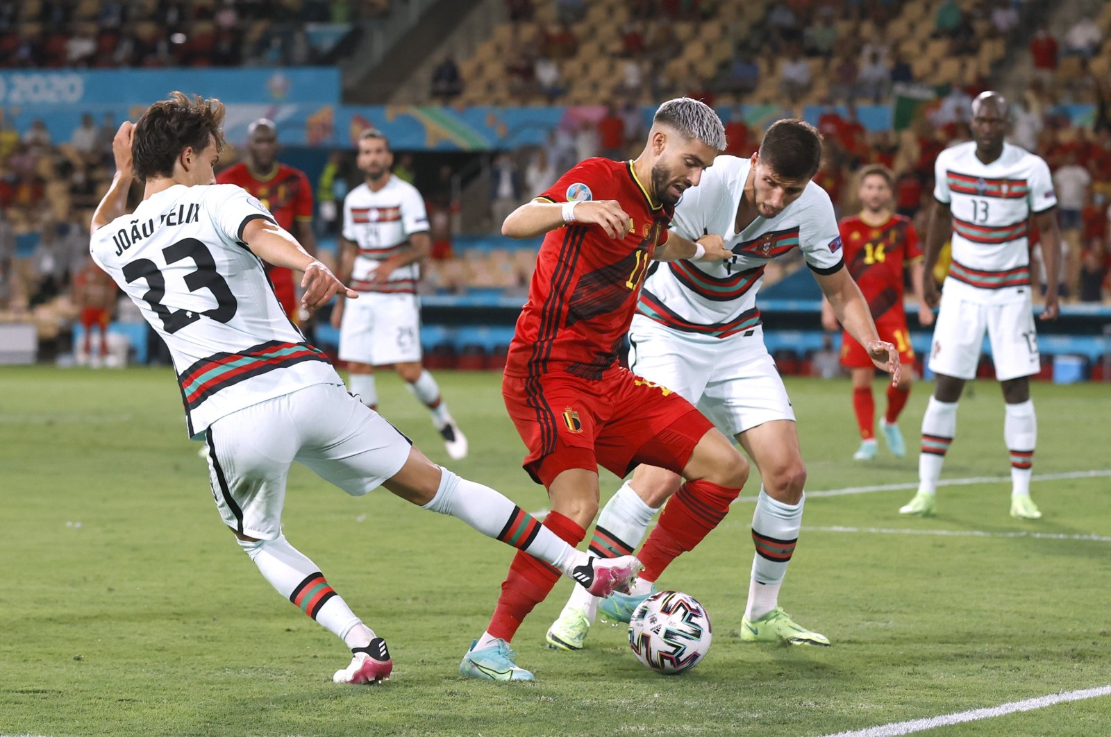 Belgium's Yannick Carrasco in action with Portugal's Ruben Dias and Joao Felix Pool, Seville, Spain, June 27, 2021. (Reuters Photo)