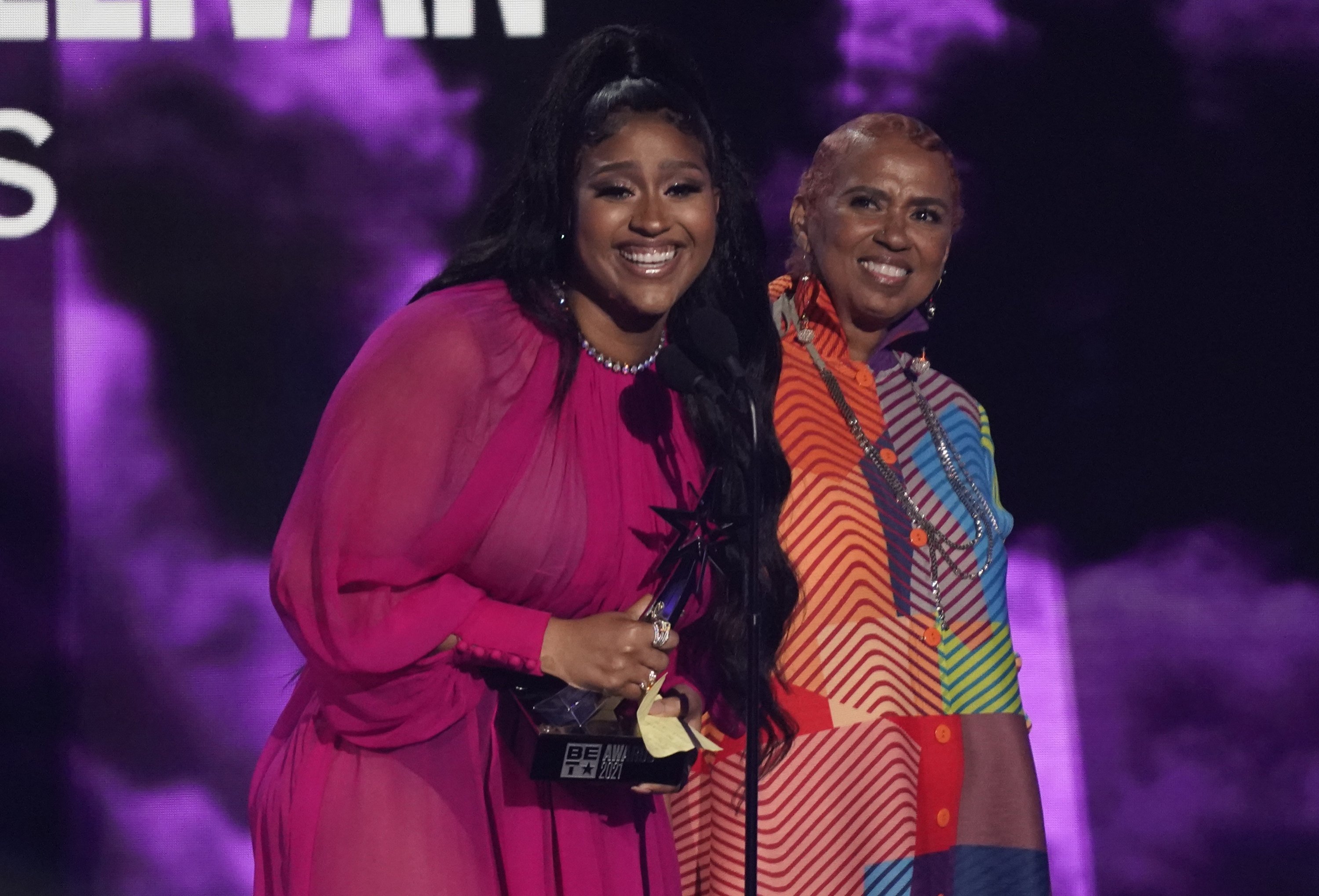 Jazmine Sullivan (L) accepts the album of the year award for "Heaux Tales" as her mother Pam Sullivan looks on, at the BET Awards at the Microsoft Theater in Los Angeles, U.S., June 27, 2021. (AP Photo)