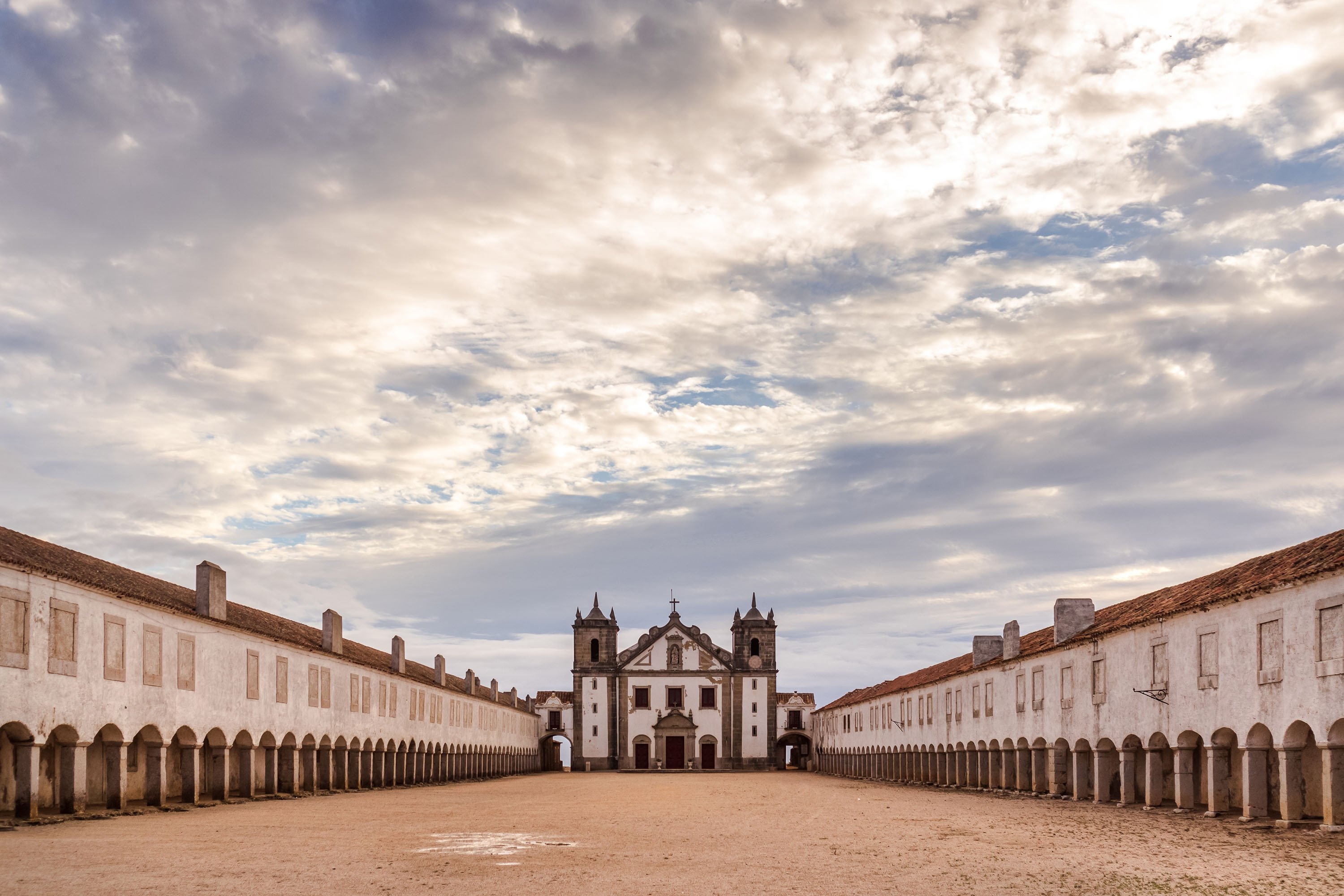 Sun shines through the clouds onto the baroque pilgrimage church Igreja de Nossa Senhora do Cabo, in Setubal, Portugal. (Shutterstock Photo)
