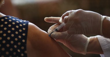 Local resident Nadezhda Dudkina receives a dose of a vaccine against the coronavirus at her home in the village of Loznoye in Volgograd region, Russia June 27, 2021. (Reuters Photo)