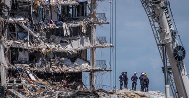 Members of the South Florida Urban Search and Rescue team look for possible survivors in the partially collapsed 12-story Champlain Towers South condo building in Surfside, Florida, U.S., June 27, 2021. (AFP Photo)