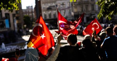 Supporters wave Turkish flags as Turkey's President Recep Tayyip Erdoğan arrives at the NATO summit in Brussels, Belgium, Sunday, June 13, 2021. (AP Photo)