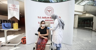 A woman gets vaccinated at a vaccination corner at Esenboğa Airport, Ankara, Turkey, June 29, 2021. (AA PHOTO)