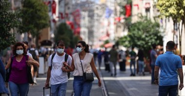People wearing protective masks walk down Istiklal Avenue, in Istanbul, Turkey, June 27, 2021. (AA PHOTO)