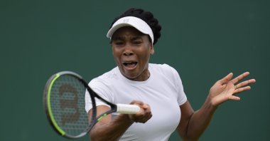 Venus Williams of the U.S. plays a return to Romania's Mihaela Buzarnescu during the women's singles first round match on day two of the Wimbledon Tennis Championships in London, June 29, 2021. (AP Photo)