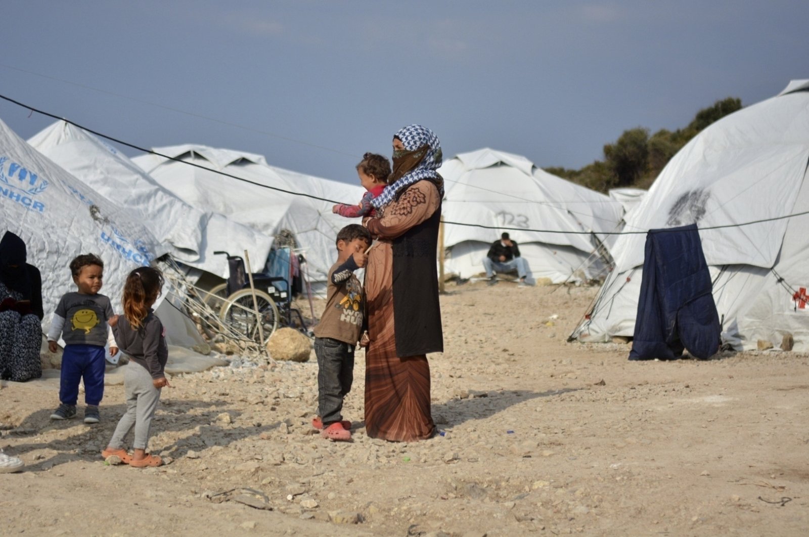 A woman holds a baby at Karatepe refugee camp, on the eastern Aegean island of Lesbos, Greece, March 29, 2021. (AP Photo)