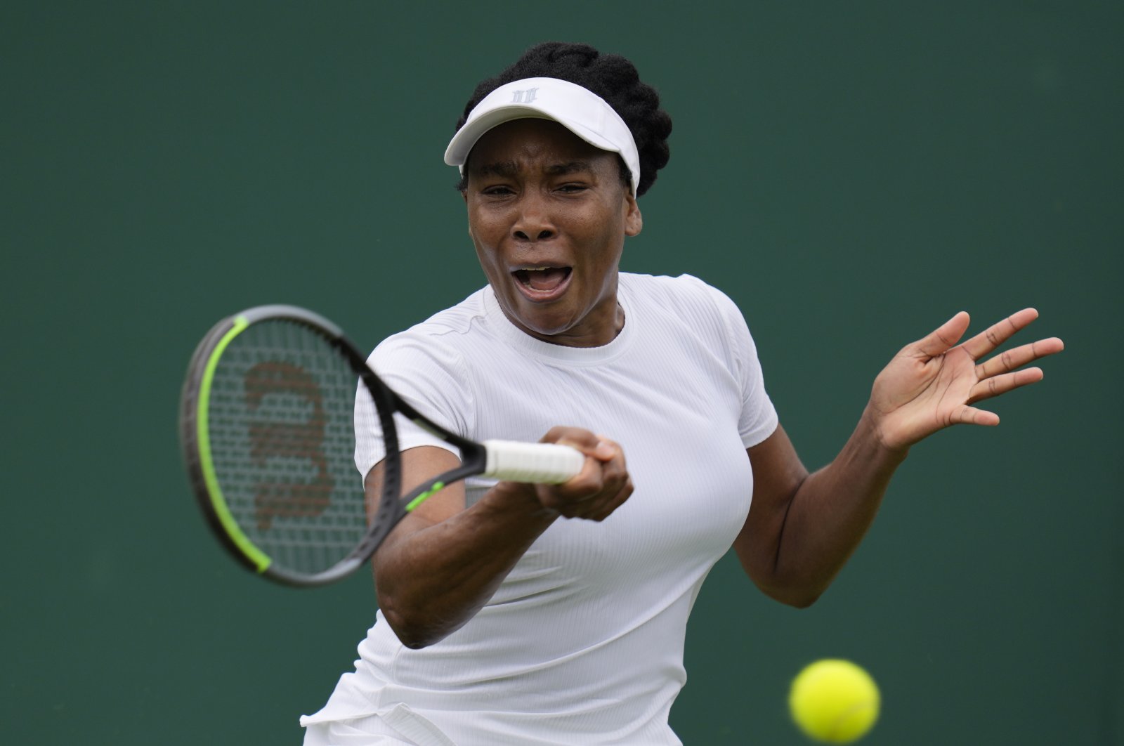 Venus Williams of the U.S. plays a return to Romania's Mihaela Buzarnescu during the women's singles first round match on day two of the Wimbledon Tennis Championships in London, June 29, 2021. (AP Photo)