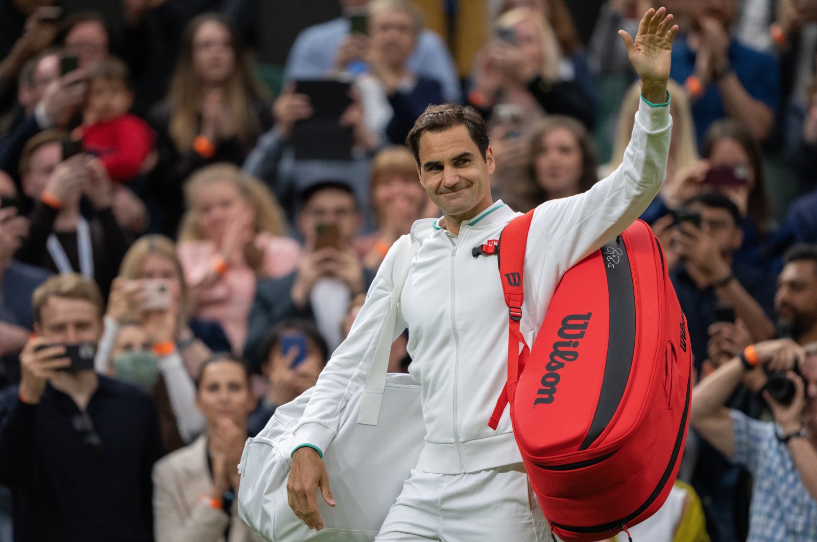 Switzerland's Roger Federer leaves court after winning his first round match against Fance's Adrian Mannarino at All England Lawn Tennis and Croquet Club, London, Britain, June 29, 2021 (Pool via Reuters)