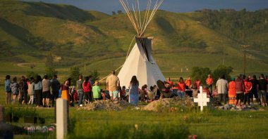 Hundreds of people gather for a vigil in a field where human remains were discovered in unmarked graves at the site of the former Marieval Indian Residential School on the Cowessess First Nation in Saskatchewan, Canada, on June 26, 2021. (AFP File Photo)