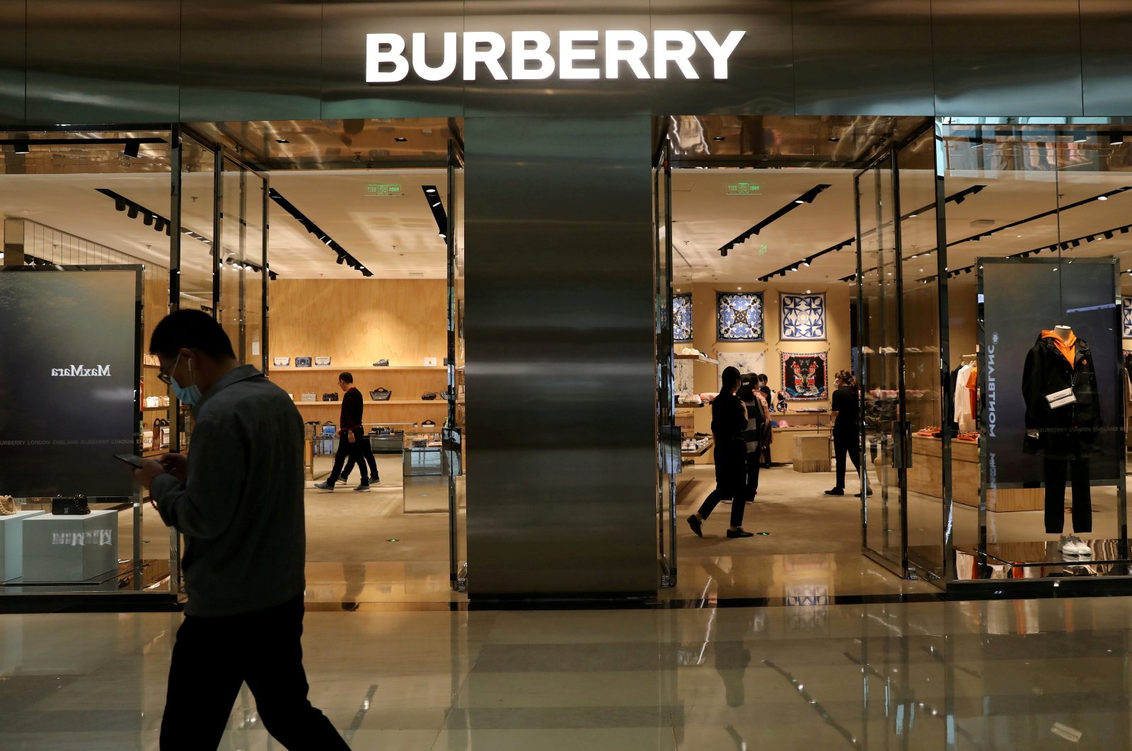A man walks past a store of luxury brand Burberry at a shopping mall in Beijing, China March 26, 2021. (Reuters Photo) 