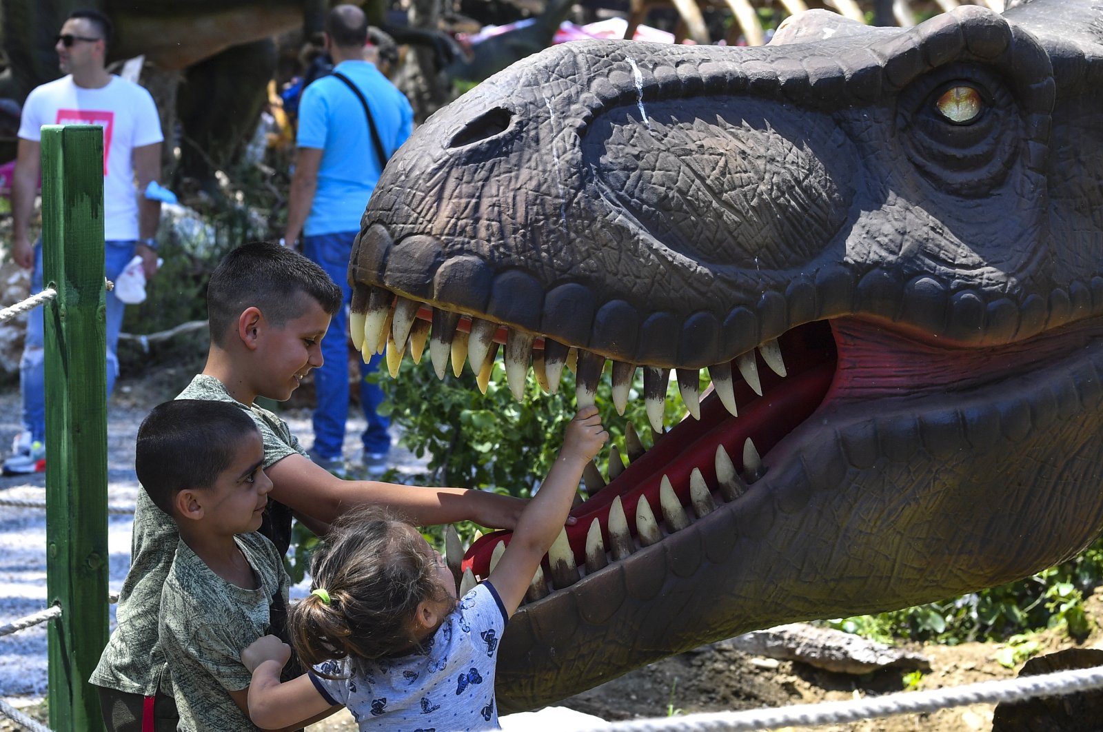 Children play with and between the replicas of dinosaurs in the newly opened Dino Park in the zoo in Skopje, Republic of North Macedonia, June 5, 2021. (EPA Photo)