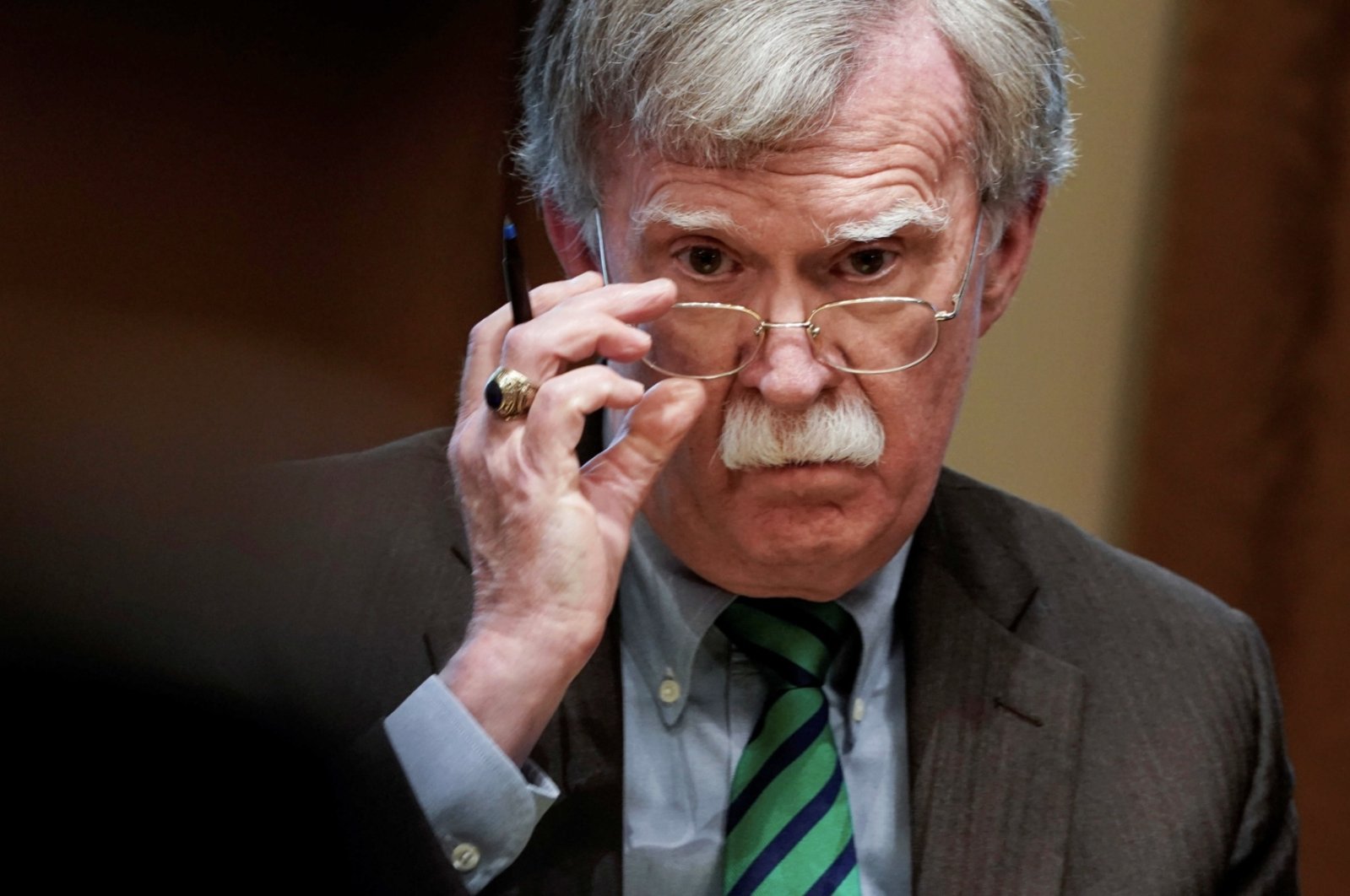 Former U.S. national security adviser John Bolton adjusts his glasses during an Oval Office meeting at the White House in Washington, April 2, 2019. (Reuters File Photo)