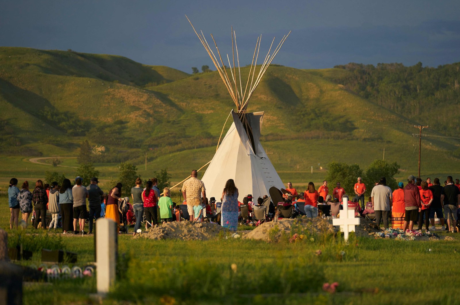 Hundreds of people gather for a vigil in a field where human remains were discovered in unmarked graves at the site of the former Marieval Indian Residential School on the Cowessess First Nation in Saskatchewan, Canada, on June 26, 2021. (AFP File Photo)