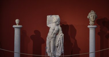 A baby head (L), the satyr relief (M) and the head of a woman, which was the first statue found in Smyrna, on display at Izmir Archaeological Museum, Izmir, western Turkey, June 30, 2021. (AA Photo)