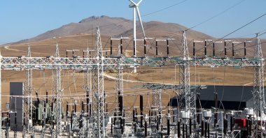 Power grids and a wind turbine are seen in the northeastern province of Bayburt, Turkey, Oct. 28, 2020. (AA Photo)