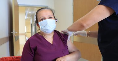 A health care worker gets vaccinated with a third dose of a COVID-19 vaccine, in Kırklareli, northwestern Turkey, July 1, 2021. (AA PHOTO)