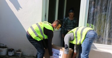 TIKA staff deliver an aid package to a family in a village near Skopje, North Macedonia, April 11, 2020. (COURTESY OF TİKA)