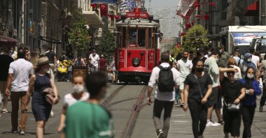 People walk on Istiklal Street, the main shopping street in Istanbul, Turkey, July 1, 2021. (AP Photo)
