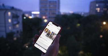 A user holds a smartphone with an opened Facebook page in Moscow, Russia, June 10, 2021. (AP Photo)