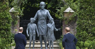 Britain's Prince William, (L) and Prince Harry unveil a statue they commissioned of their mother Princess Diana,  on what would have been her 60th birthday, in the Sunken Garden at Kensington Palace, London, U.K., July 1, 2021. (AP Photo)