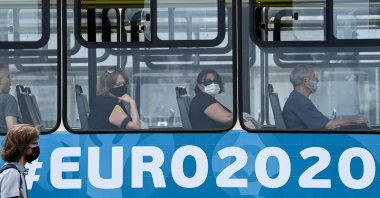 People, wearing a face mask amid the ongoing COVID-19 pandemic, sit in a tram in St. Petersburg, June 29, 2021. (AFP Photo)