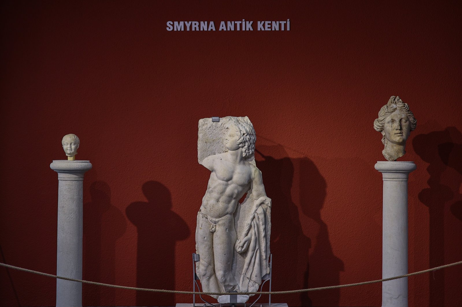 A baby head (L), the satyr relief (M) and the head of a woman, which was the first statue found in Smyrna, on display at Izmir Archaeological Museum, Izmir, western Turkey, June 30, 2021. (AA Photo)