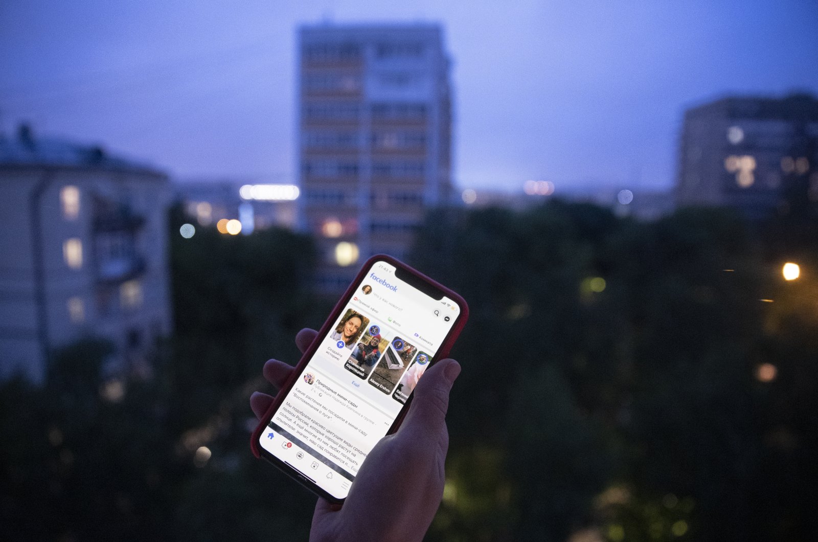 A user holds a smartphone with an opened Facebook page in Moscow, Russia, June 10, 2021. (AP Photo)