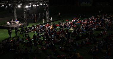 Foreign Minister Mevlüt Çavuşoğlu (C) and Anadolu Efes Coach Ergin Ataman (R) sit on stage during a meeting of the Youth Forum as part of the Antalya Diplomacy Forum, Antalya, southern Turkey, June 20, 2021. (AA Photo)
