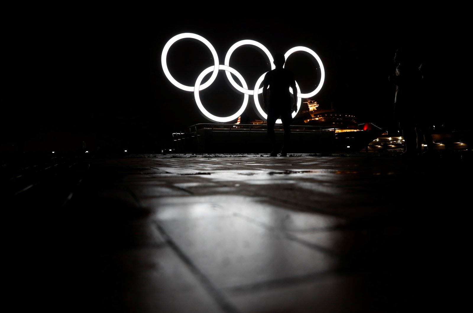 Visitors look at newly installed Olympic rings for celebrating the 2020 Tokyo Olympic Games in Yokohama, Japan, June 30, 2021. (Reuters Photo)