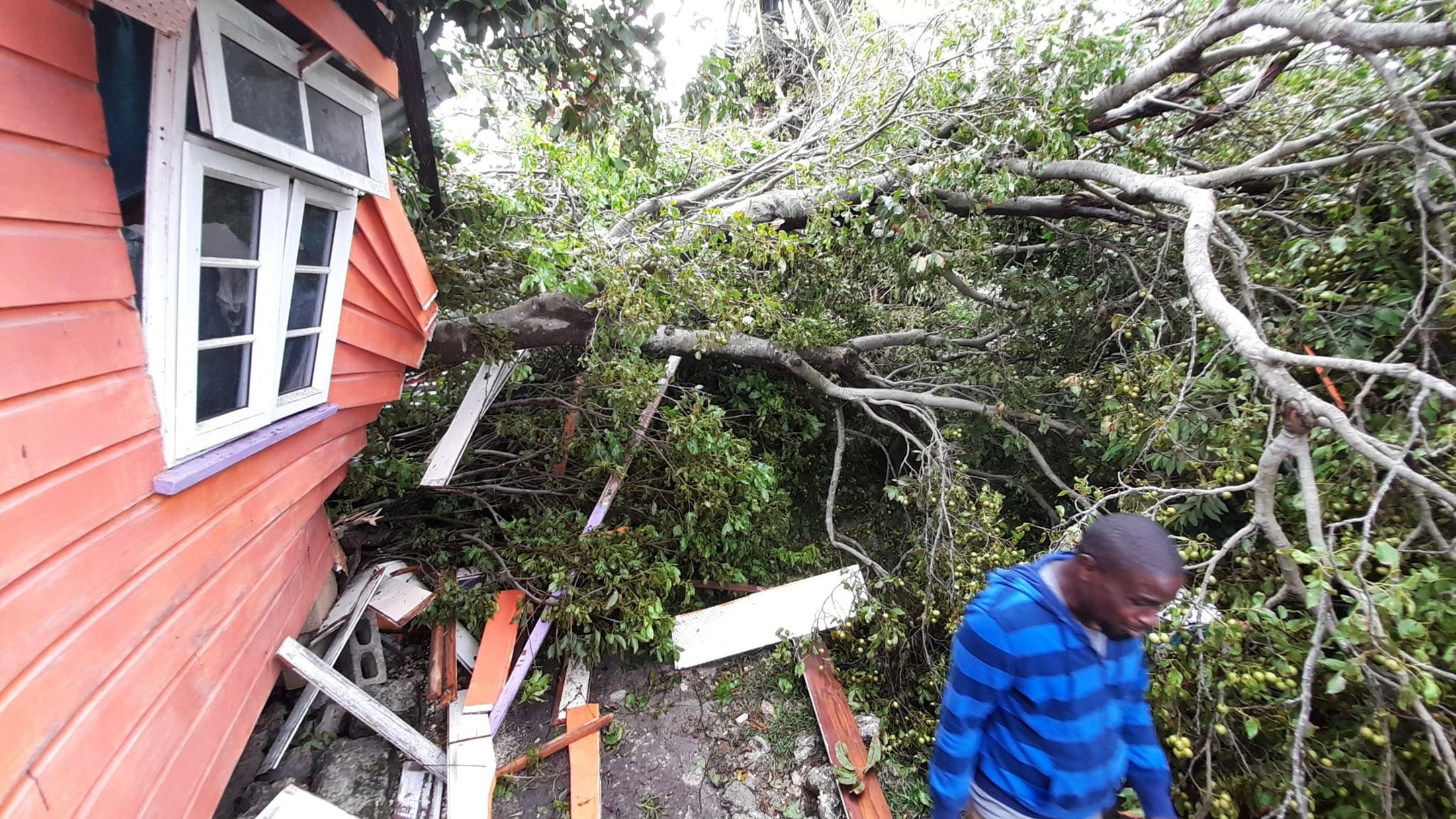 A man views damage to a home after strong winds of Hurricane Elsa passed St. Michael, Barbados, July 2, 2021. (Reuters Photo)