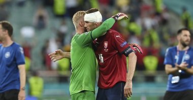 Denmark's goalkeeper Kasper Schmeichel (L) embraces Czech Republic's Tomas Soucek at the end of the Euro 2020 soccer championship quarterfinal match between the Czech Republic and Denmark, at the Olympic stadium in Baku, Azerbaijan, July 3, 2021. (Ozan Kose, Pool Photo via AP)