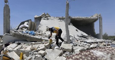 A civil defense worker inspects a damage house after shelling hit the town of Ibleen, a village in southern Idlib province, Syria, Saturday, July 3, 2021. (AP Photo)