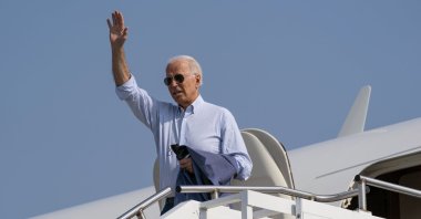 U.S. President Joe Biden waves as he boards Air Force One upon departure from Cherry Capital Airport in Traverse City, Michigan, U.S., July 3, 2021. (AP Photo)