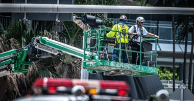 Rescuers and firefighters inspect the balconies of the partially collapsed 12-story Champlain Towers South condominium building ahead of its demolition, Surfside, Florida, U.S., July 4, 2021. (AFP Photo)