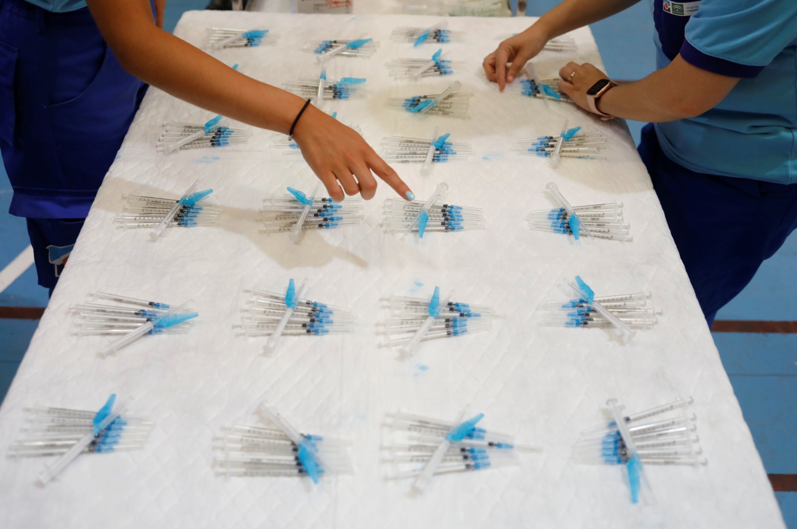 Healthcare workers prepare syringes to be filled with the Pfizer-BioNTech COVID-19 vaccine at a vaccination center in Ronda, Spain, June 30, 2021. (Reuters Photo)