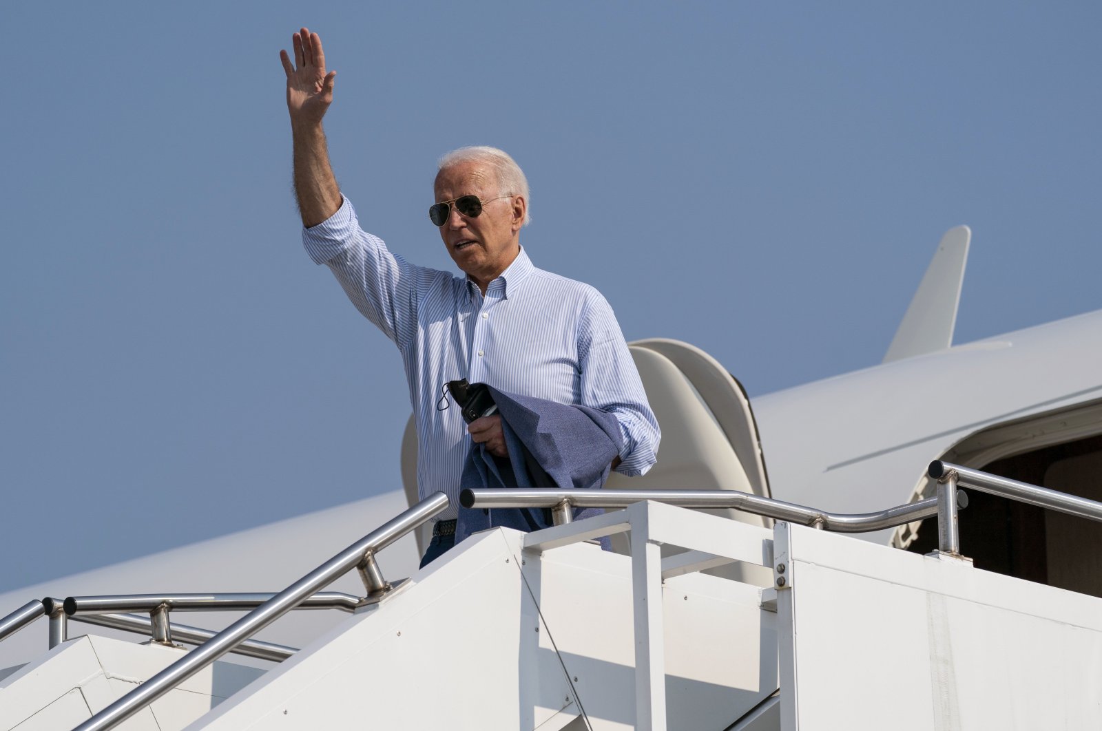 U.S. President Joe Biden waves as he boards Air Force One upon departure from Cherry Capital Airport in Traverse City, Michigan, U.S., July 3, 2021. (AP Photo)