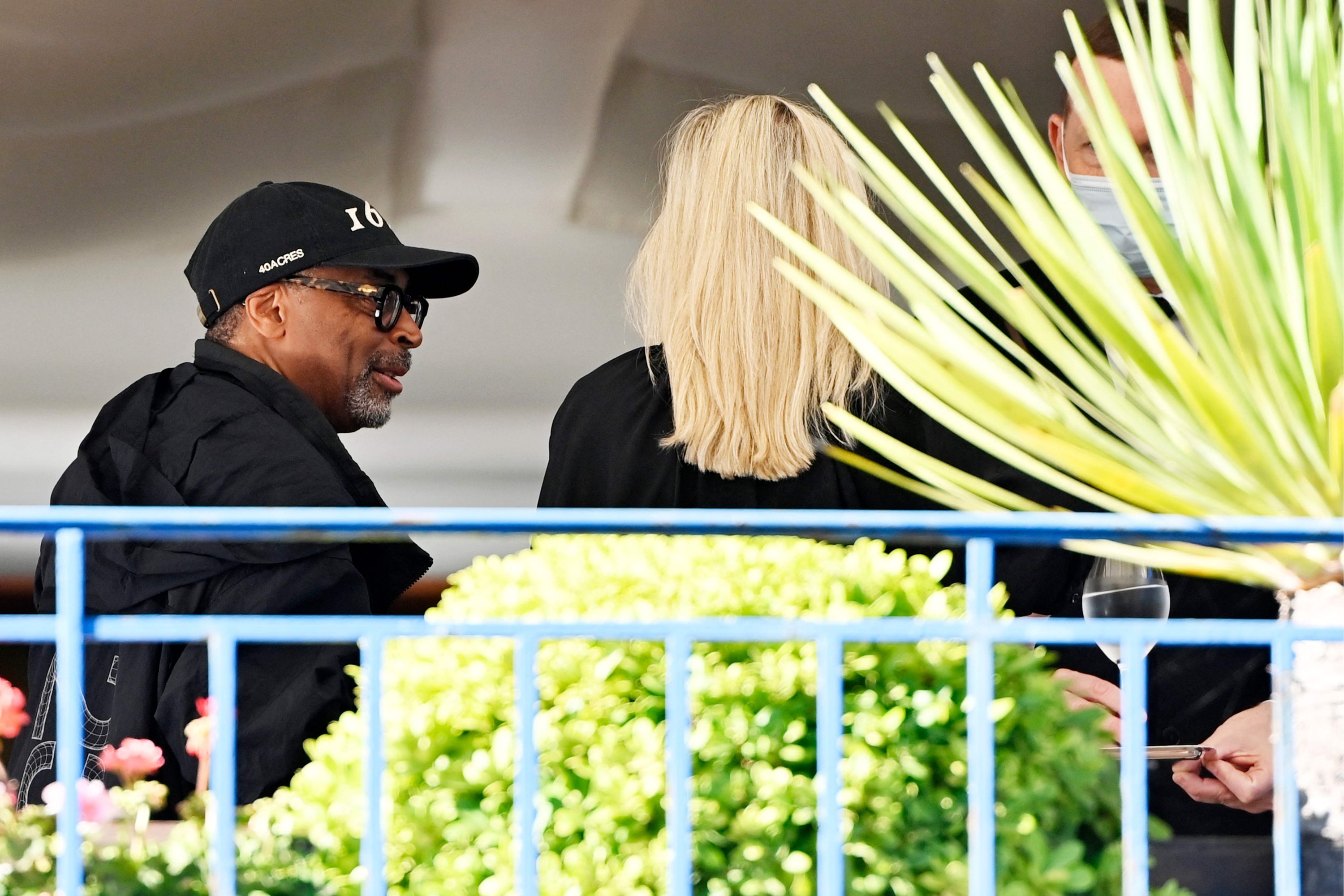 U.S. director and jury president, Spike Lee (L), speaks with Austrian director and jury member, Jessica Hausner, on the balcony of the Martinez Hotel on the eve of the opening of the 74th Cannes Film Festival in Cannes, France, July 5, 2021. (AFP Photo)