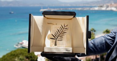A Chopard representative displays the Palme d'Or, the highest prize awarded to competing films, during an interview before the start of film festival, Cannes, France, July 5, 2021. (Reuters Photo)