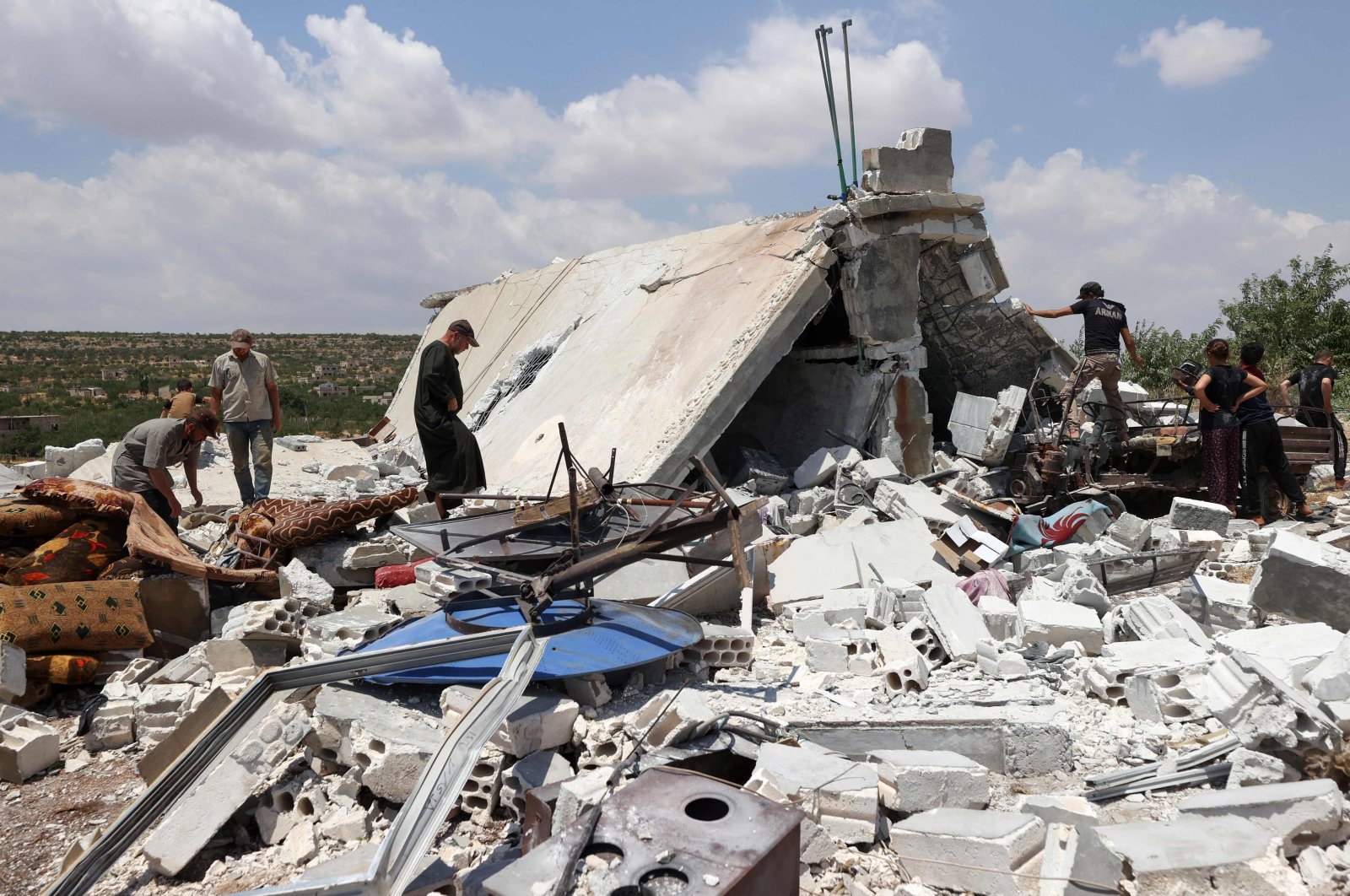 People salvage belongings from a house destroyed by a Russian missile attack in the Jabal al-Zawiya region in opposition-held Idlib province, Syria, July 4, 2021. (AFP Photo)