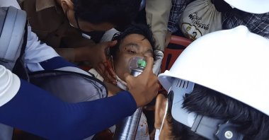 In this Sunday, Feb. 28, 2021 image from video provided by Dakkhina Insight, medics attend to a man who appeared to be wounded in his upper chest on a street in Dawei, Myanmar. (AP Photo)