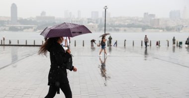 A woman walks in the rain, in Istanbul, Turkey, July 6, 2021. (AA PHOTO) 