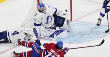 Montreal Canadiens Josh Anderson (2nd L) scores past Tampa Bay Lightning goaltender Andrei Vasilevskiy (2nd R) during overtime of Game 4 of the Stanley Cup final in Montreal, Canada, July 5, 2021. (AP Photo)