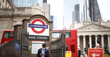 A person exits the Bank underground station in the City of London financial district in London, U.K., June 11, 2021. (Reuters Photo)